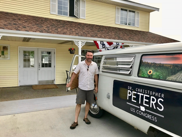 Chris Peters beside a campaign van