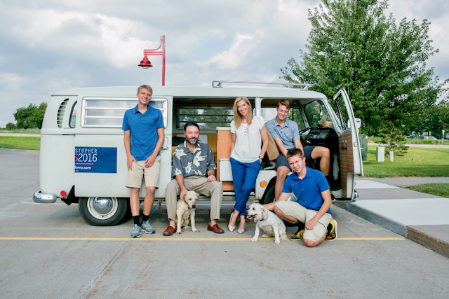 Chris Peters with family and campaign dogs beside a campaign van