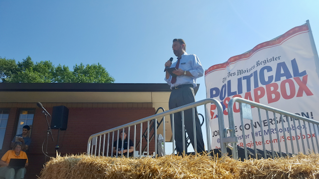 Chris Peters speaking from a political soapbox stage